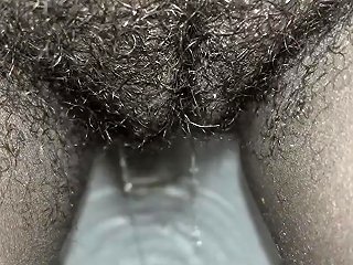 Fetish Video Featuring A Black Woman With Hairy Genitalia Urinating